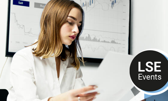 A woman looking at sheets of paper