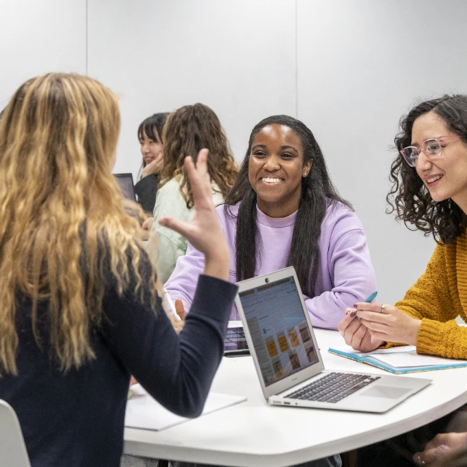 Students chatting and smiling in a classroom