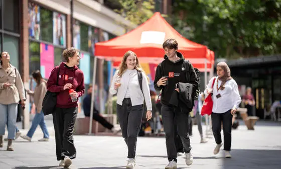 Students walking and chatting on campus