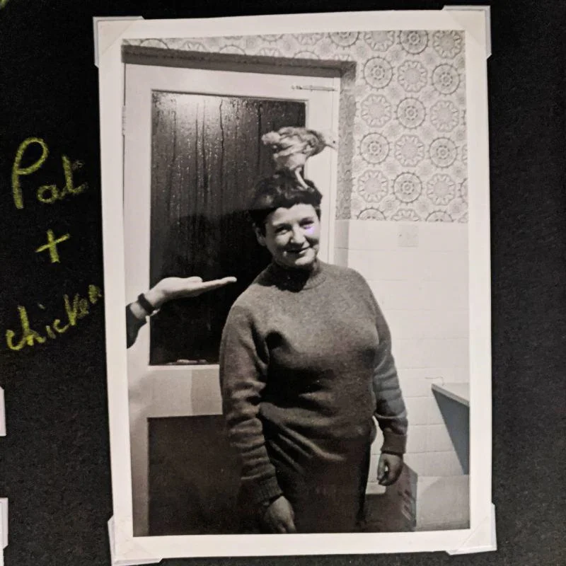 Pat Arrowsmith with a chicken on her head.