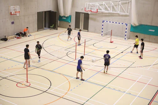 Students playing badminton at LSE on campus