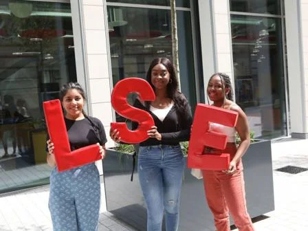 students on campus with LSE sign 747x560