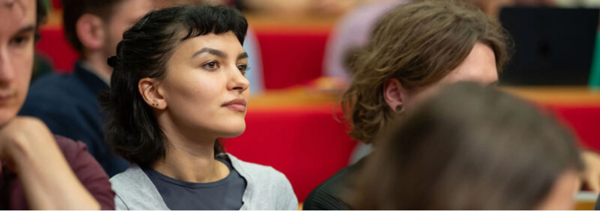 A woman listening to a lecture