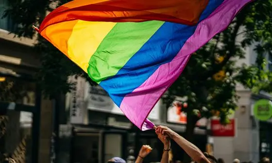 People waving a rainbow flag.