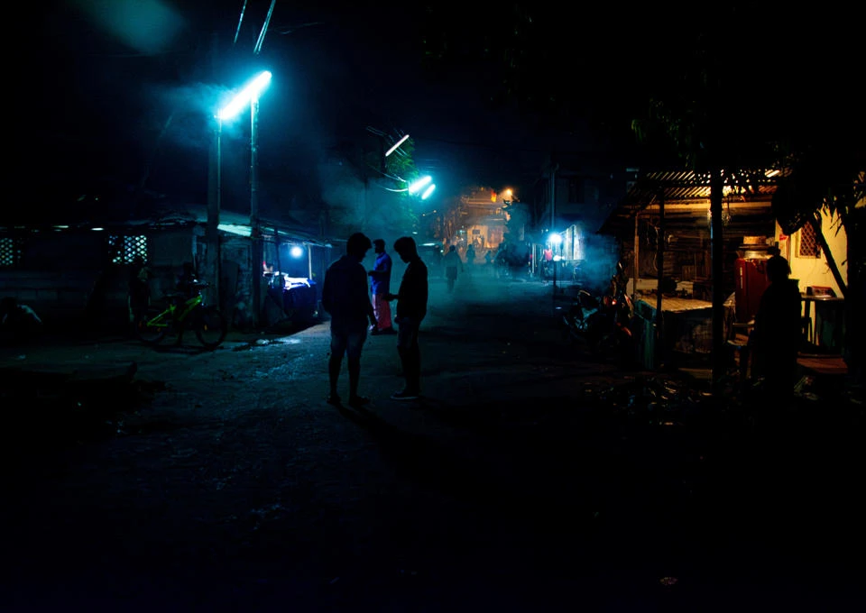 A dark street with lighting.