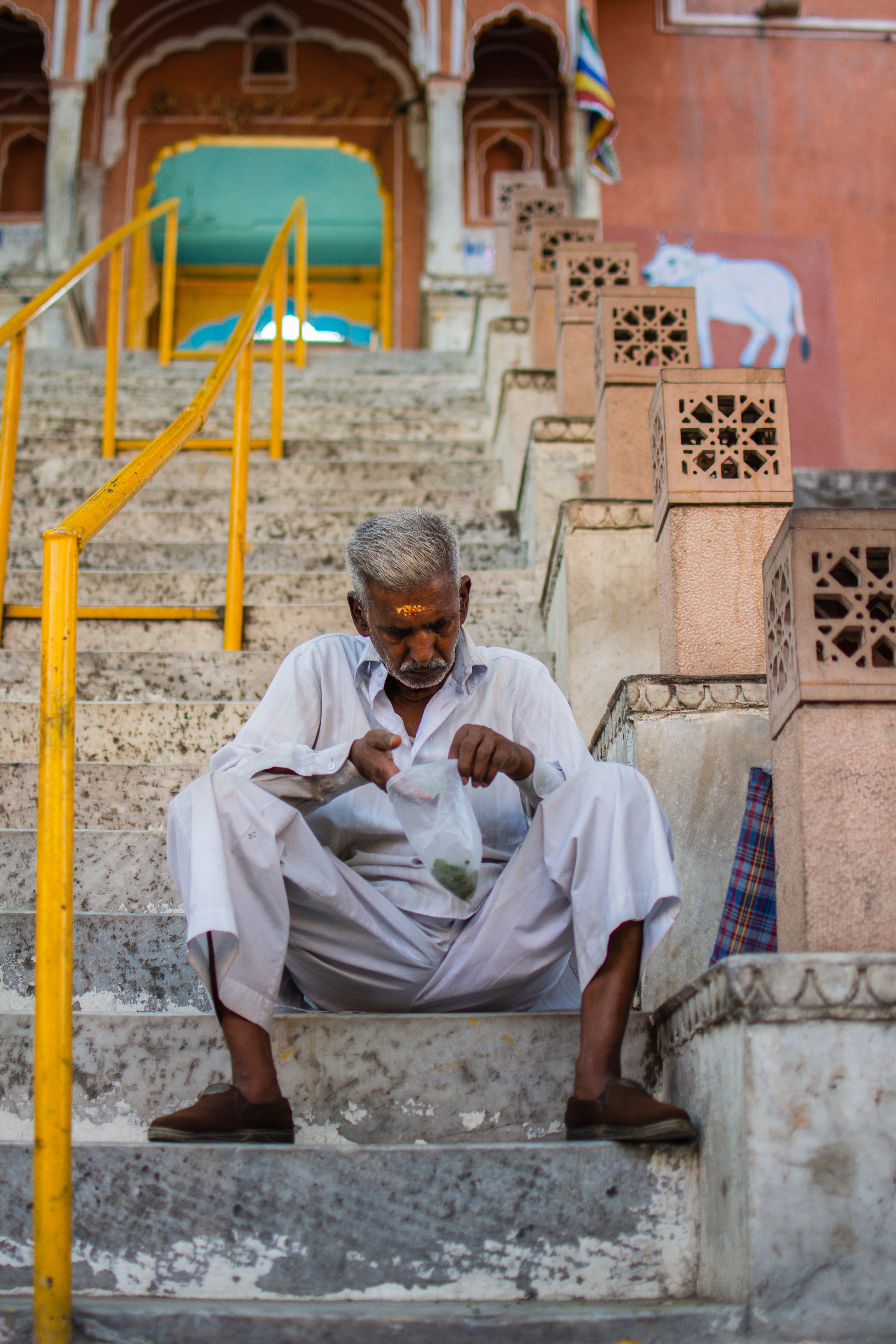 India man sitting on steps