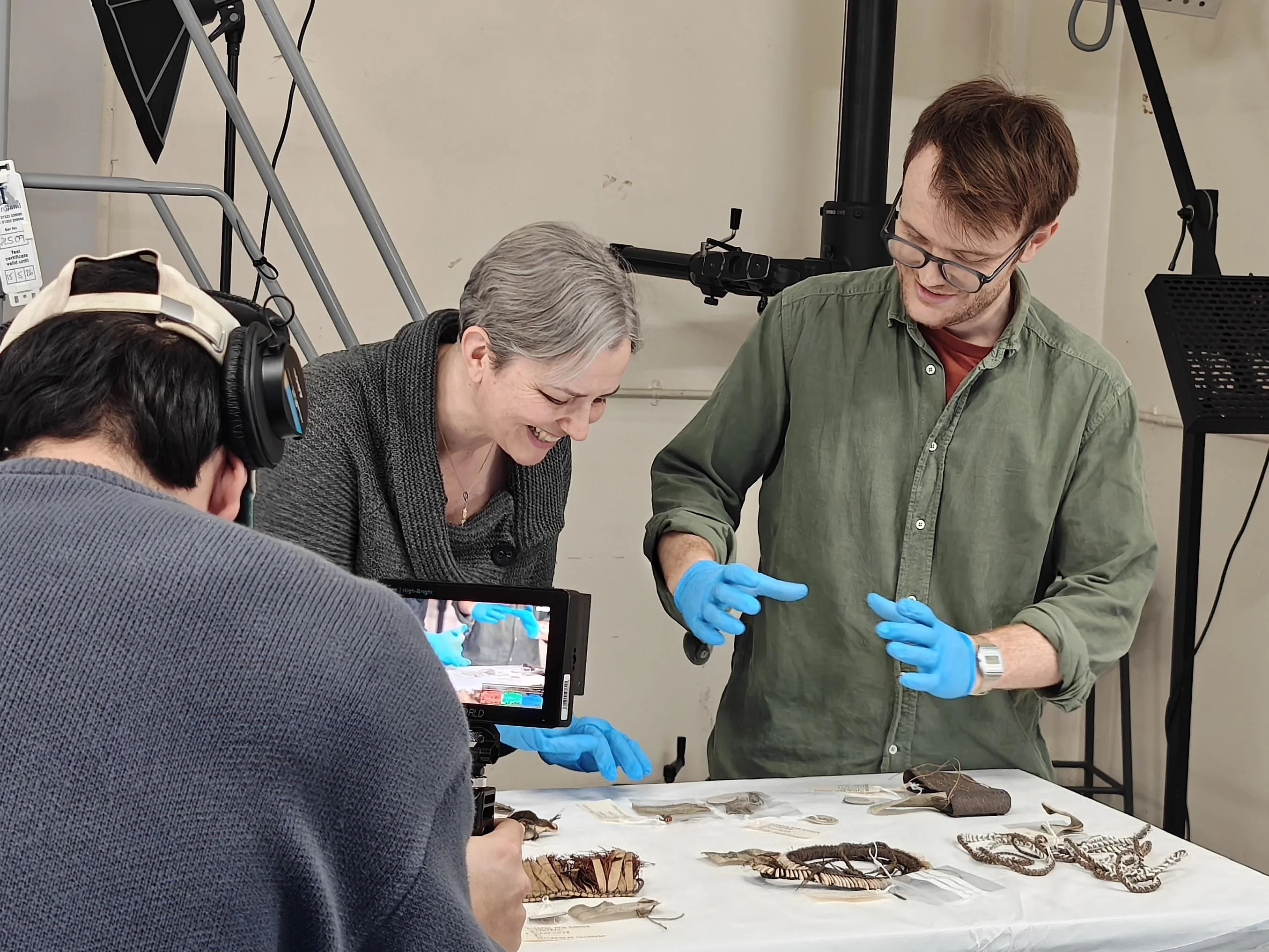 Vicky and two other people looking at artefacts