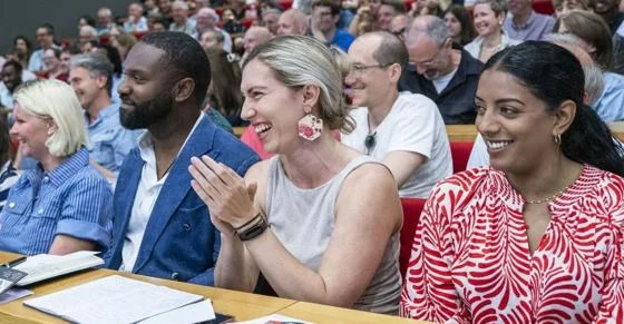 Events audience clapping and smiling