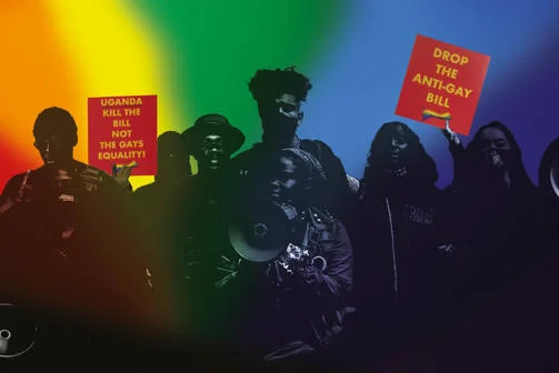 A crowd of people with protest signs that say 'Drop the anti-gay bill' and 'Uganda kill the bill'.