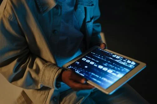 hands holing an ipad