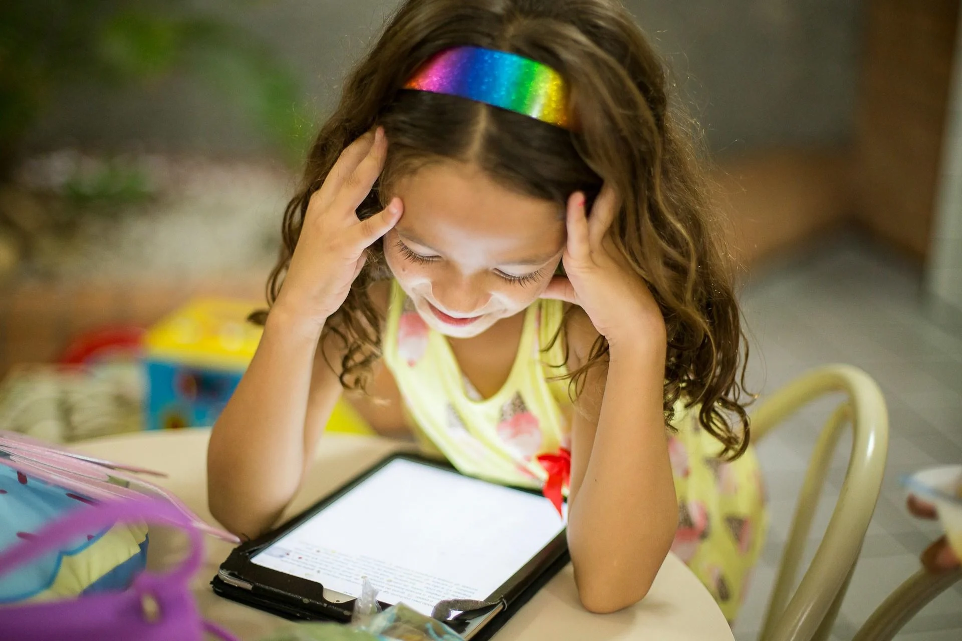 Young girl gazing at tablet