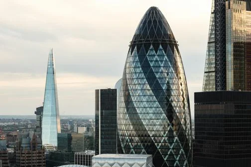 city of london skyline, with 30 St Mary Axe, know as the 'Gherkin', in the foreground and Shard in the background.