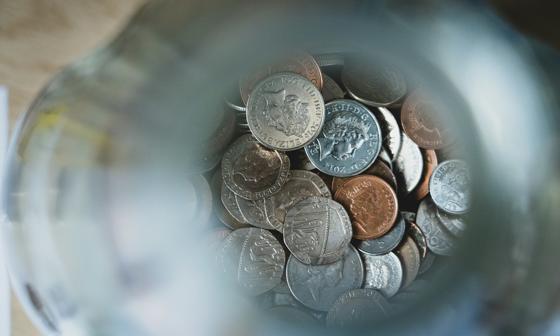 View looking down into a jar with coins in.