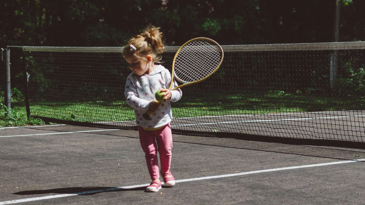 A child holding a tennis racquet