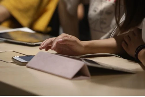 Student typing on a tablet