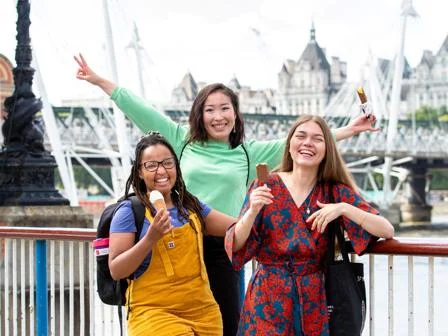 three students smiling