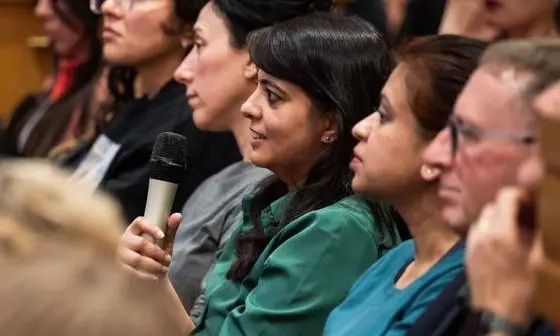 woman holding microphone in audience
