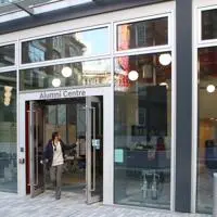 Woman leaving the LSE alumni centre building