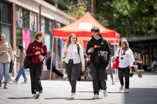 Students walking and chatting on campus