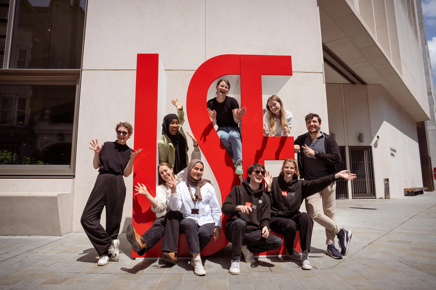 Students standing in front of LSE sign