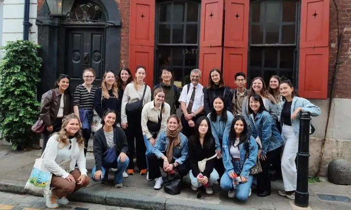 Group of students smiling outside museum