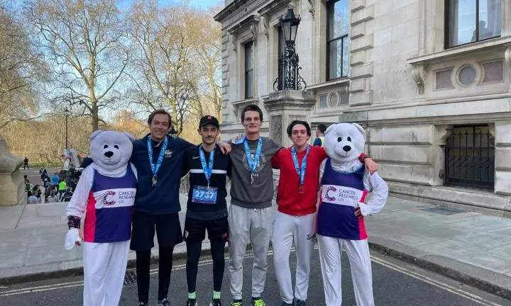 Four students wearing medals and two people dressed up as polar bears