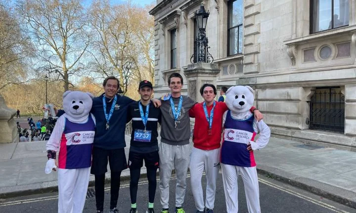 Four students wearing medals and two people dressed up as polar bears