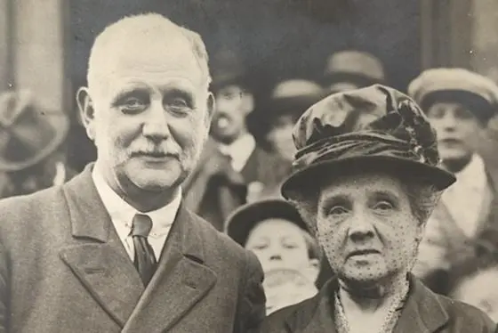 Two people stood photographed amongst a crowd