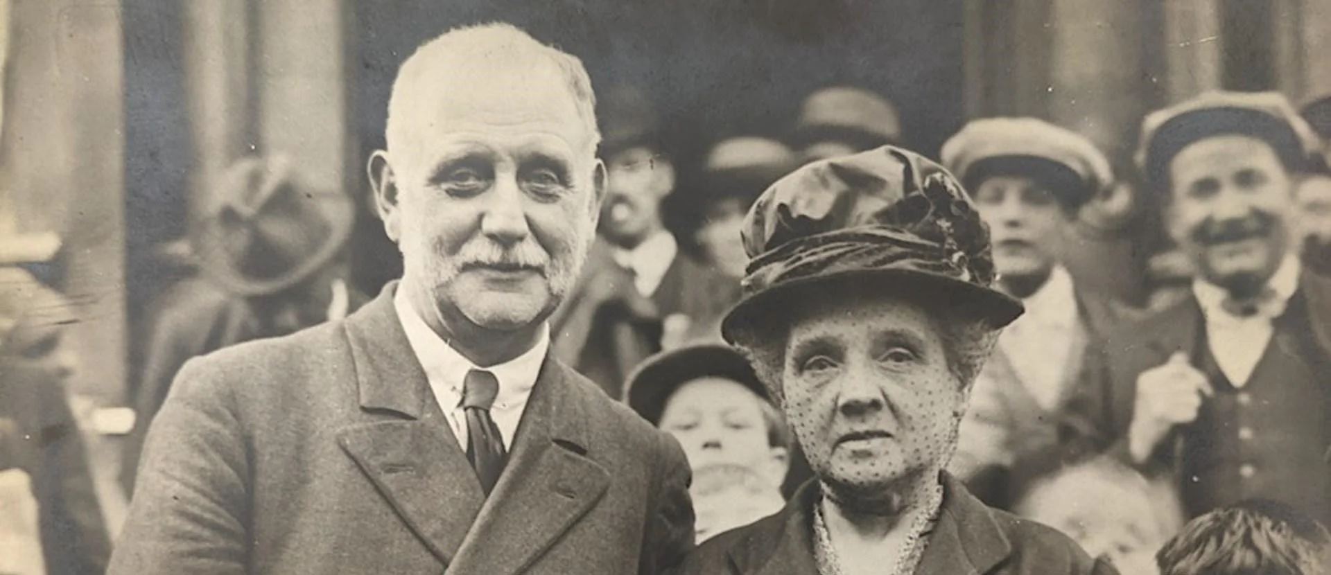 Two people stood photographed amongst a crowd