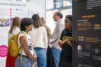 Students talking at exhibition