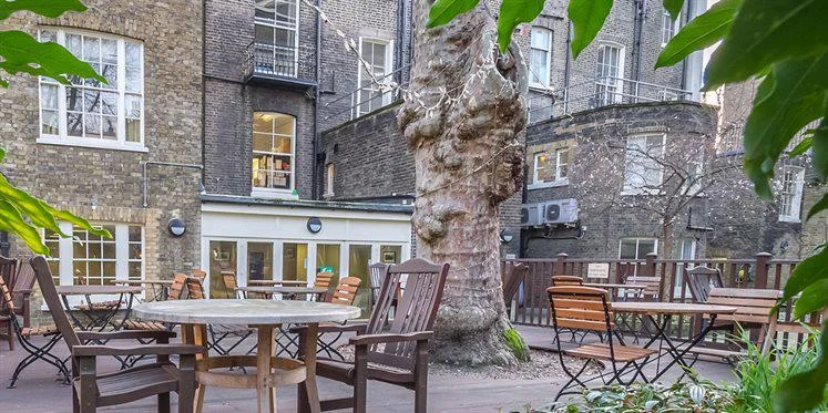 A courtyard garden with tables and chairs
