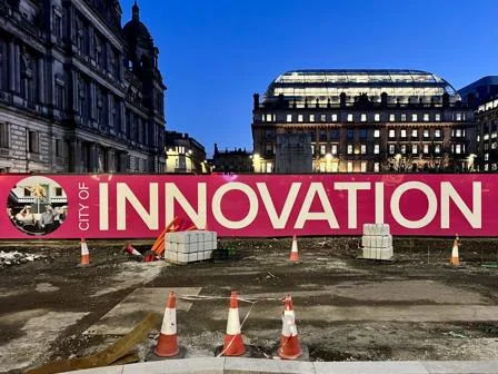 Glasgow, evening, large banner saying "INNOVATION".