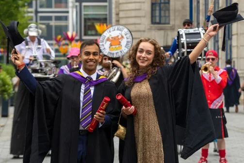 Graduates celebrating following their ceremony on campus.