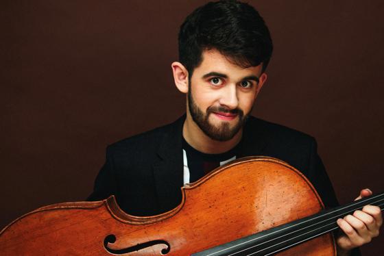Hugh Mackay holding a cello.