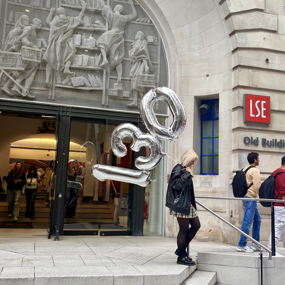A girl carries silver 130 balloons