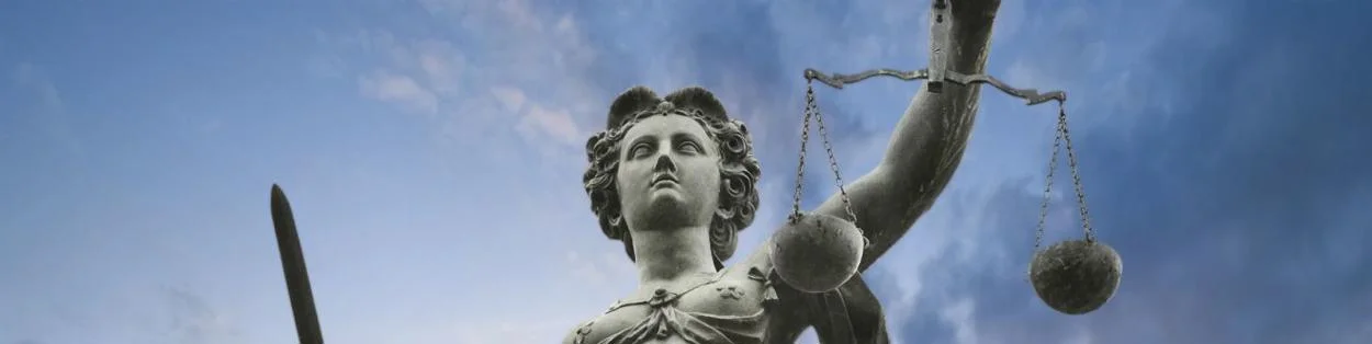 a statue of a woman holding scales