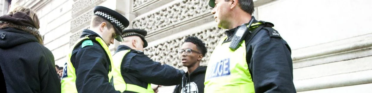 UK policemen speaking to a young man