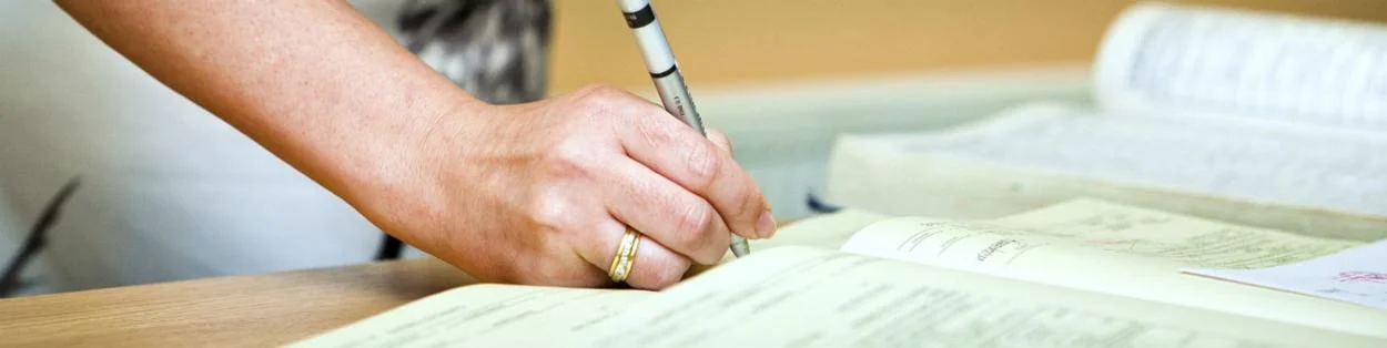 a woman writing in a book