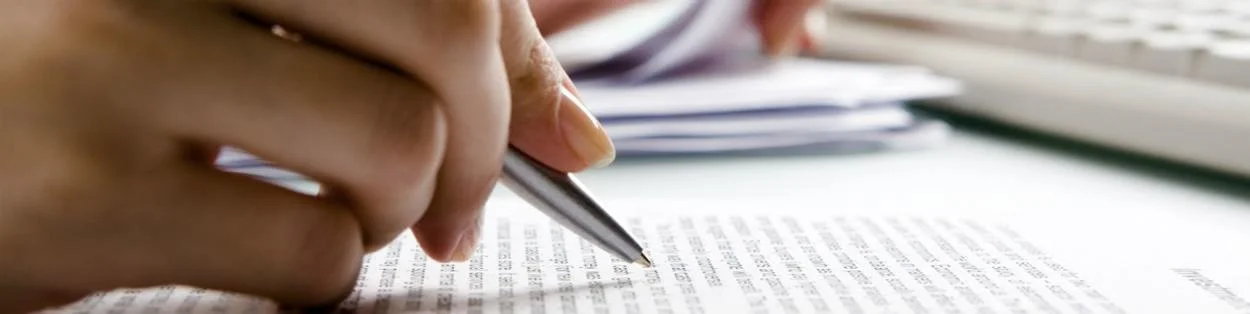 a person writing in a book