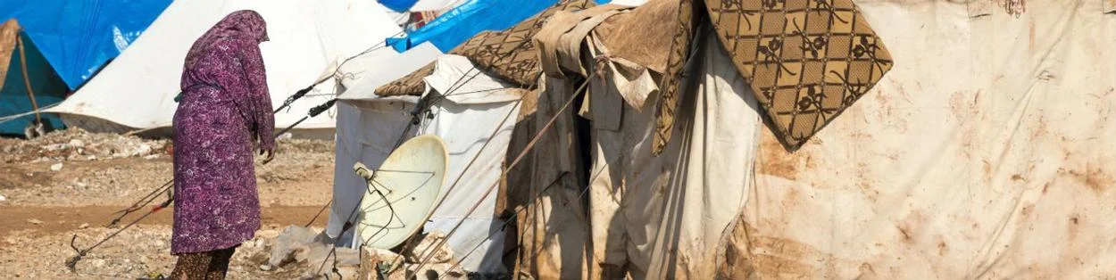 a woman walking by a campsite