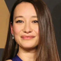 Joanna is smiling at the camera.
