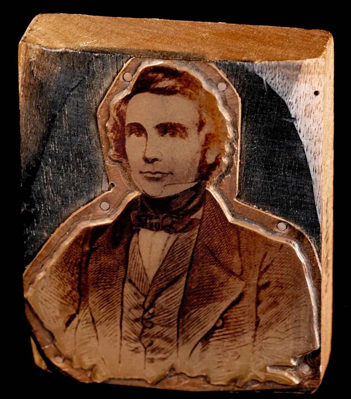 A wooden block featuring William Lovett.