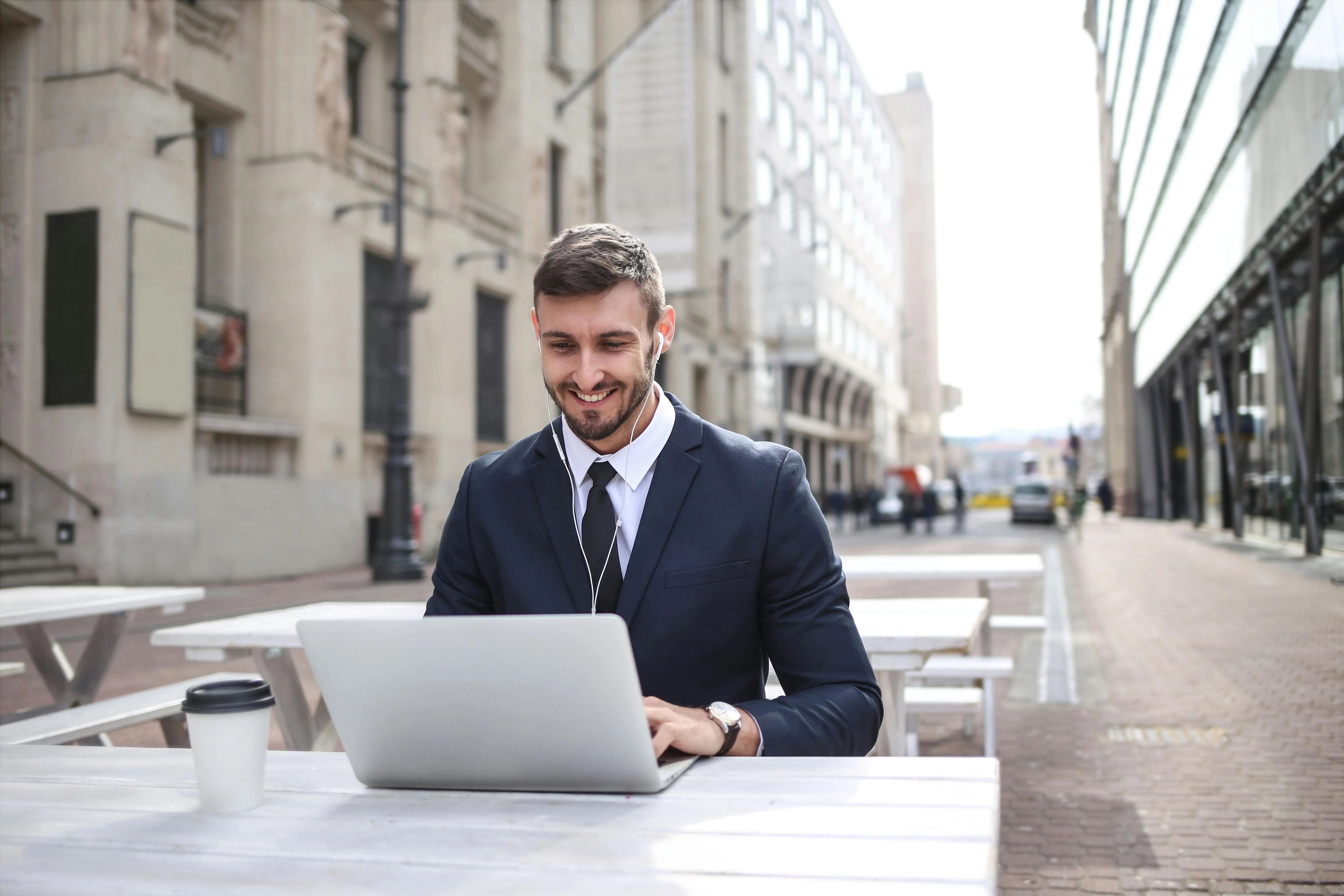 Male working on a laptop outside in London