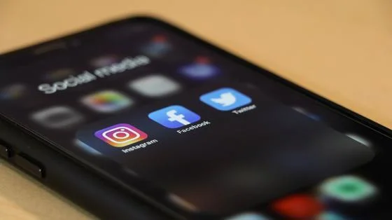 A mobile phone showing social media symbols
