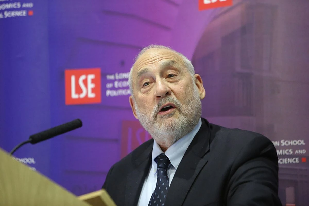 Joseph Stiglitz speaking in front of an LSE banner.