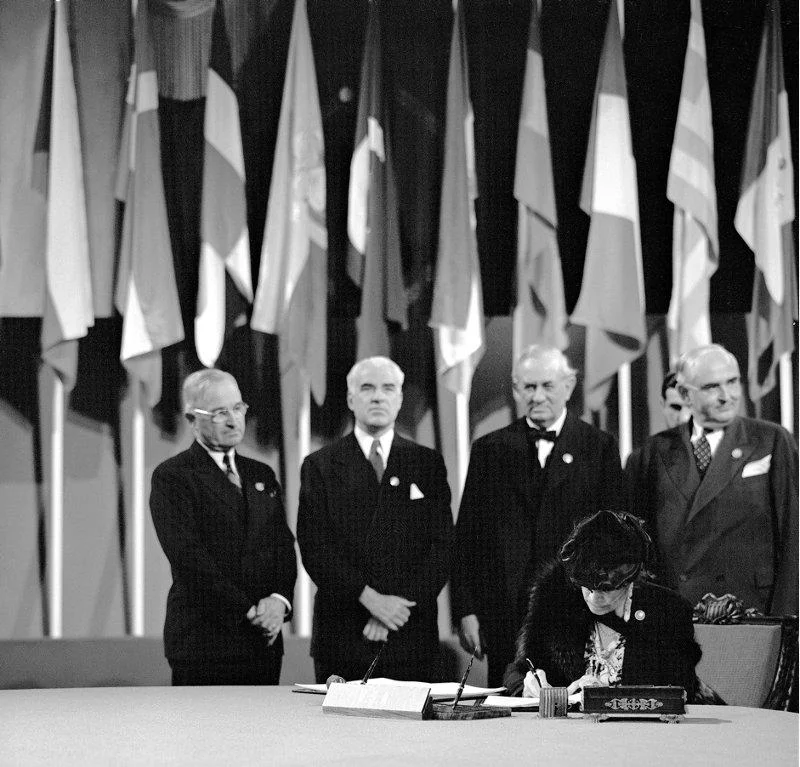 Dean Virginia C. Gildersleeve, member of the Delegation from the United States, signing the United Nations Charter at a ceremony held at the Veterans' War Memorial Building on 26 June 1945, San Francisco, United States.