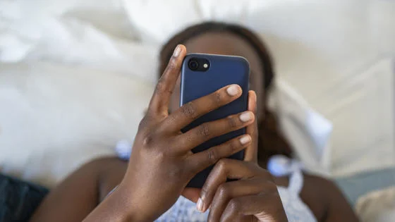 Female behind a phone while using it