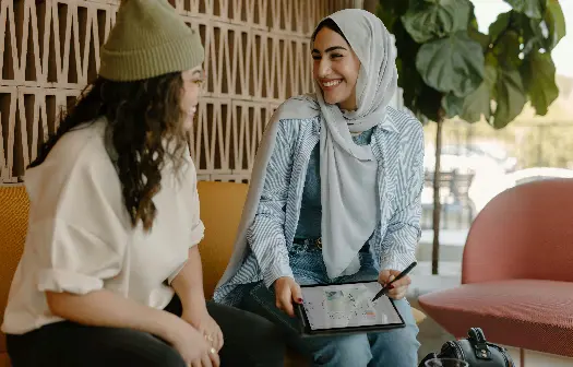 Two women talking with tablet