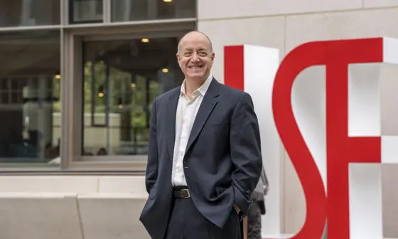Larry Kramer, LSE President and Vice Chancellor, with the LSE letters