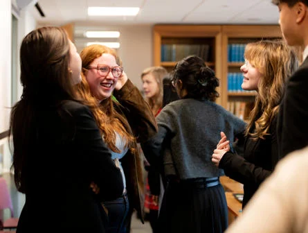 group of students smiling in discussion